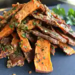Tender and flavorful roasted sweet potato and beef jerky seasoned with herbs and spices, perfect as a healthy dog treat or snack for your furry friend on Waggy Chef.