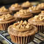 Creamy peanut butter and chopped peanuts on top of a freshly baked, crumbly cookie cupcake. Perfect for dog treats or human desserts, featuring a rich, nutty flavor.
