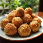 Jumbo meatballs on a white plate with a rustic background, showcasing delicious, savory, homemade meatball recipe. Perfect for Italian cuisine, family dinners, and party appetizers.