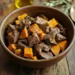 Savory beef and sweet potatoes stew in a rustic wooden bowl, perfect for comforting dog food or pet treats, showcasing a hearty and nutritious meal option.