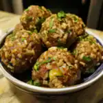 Savory homemade meatballs made with rice, herbs, and spices, garnished with fresh parsley in a stylish bowl; perfect for comforting Asian-inspired cuisine or family dinners.