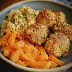 Crab cakes with roasted sweet potatoes and seasoned rice on a plate featuring Waggy Chef cuisine.
