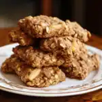 Homemade oatmeal cookies with chunks of nuts on a decorative plate, perfect for pet snacks and treats.