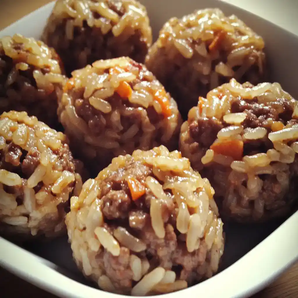 Savory beef and rice meatballs, glazed with sauce, close-up of homemade dog treats, healthy pet food snacks, Waggy Chef pet treat recipe, dog meal inspiration, healthy dog food option, pet nutrition, gourmet dog treats, high-quality pet treats.