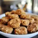 Crunchy homemade dog treats with oats and peanut butter on a white plate, perfect for pet snacks and training. Healthy, natural ingredients for dog nutrition and treats from Waggy Chef.