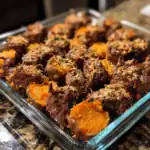 Succulent sweet potato and beef stew bites with crunchy topping in glass dish, healthy homemade dog treat from Waggy Chef.