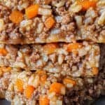 Savory beef and rice casserole slices with carrots, home-cooked comfort food, Waggy Chef gourmet dish, delicious layered casserole, hearty homemade rice and ground beef skillet.