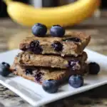 Delicious homemade blueberry oatmeal bars with fresh blueberries on top, perfect for a healthy snack or breakfast, featured on Waggy Chef.