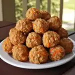 Savory homemade meatballs with grated carrots on white plate for waggy chef website.