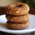 Oatmeal raw dog treats stacked on a white plate, healthy homemade dog snack, natural ingredients.