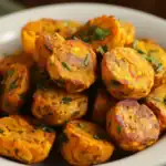 Flavorful Indian-style vegetable and chickpea balls, golden crispy exterior garnished with fresh herbs, perfect for a delicious vegan appetizer or snack.