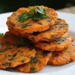 Crispy herb veggie fritters on white plate, garnished with fresh parsley, close-up, vegetarian healthy snack, homemade savory cakes, colorful and tasty, food photography.