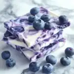 Fresh blueberry-flavored marshmallow ice cream bars with blueberries on top, crafted for dog treats by Waggy Chef. Perfect for pet-friendly snacking, made with organic ingredients and a tasty blueberry twist.