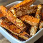 Juicy, crispy baked chicken strips with tender carrots in a white dish, showcasing homemade pet-friendly chicken recipes with flavorful seasoning and perfect for dogs.