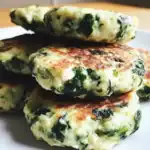 Crispy spinach and feta cheese veggie patties, healthy vegetarian breakfast or snack options, close-up of delicious homemade potato pancakes with spinach, doritos, crispy texture, fresh ingredients, Waggy Chef.