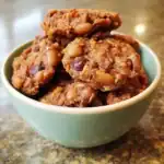 Chewy homemade bean and oatmeal cookie bites in a light blue ceramic bowl on a kitchen countertop. Perfect for pet treats, made with healthy ingredients, and designed for dogs and other furry friends.