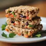 Delicious homemade healthy oatmeal energy bars with mixed nuts, dried fruits, and seeds, perfect for quick snacks and outdoor activities.