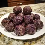 Frozen purple sweet potato energy balls on a white plate for healthy snacks.