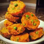 Crispy vegetable fried cutlets with green peas in a white bowl, seasoned Indian snack, vegetarian street food, Waggy Chef.