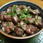 Savory beef stew with tender chunks of beef, fresh herbs, served over rice in a black bowl for a delicious Waggy Chef meal.