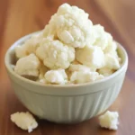 Creamy cauliflower florets in a white bowl for healthy vegetarian snacks and recipes. Perfect for dairy-free diets and nutritious side dishes. Fresh, steamed cauliflower ready to serve.