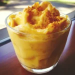 Creamy mashed sweet potatoes with cinnamon spice in a clear glass bowl, perfect for cozy desserts or healthy snacks.
