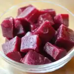 Juicy homemade beetroot cubes in a clear glass bowl, perfect for healthy snacks or salads. Fresh, vibrant, nutrient-rich, and delicious, ideal for adding color and flavor to your meals.