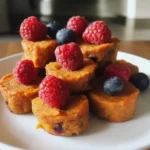 Sweet potato dog treats topped with fresh raspberries and blueberries, perfect for healthy homemade pet snacks from Waggy Chef.
