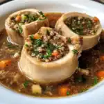 Creamy stuffed chicken breast with quinoa, vegetables, and fresh herbs in a savory broth. Perfect for a nutritious, flavorful meal with a professional presentation.