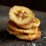 Fresh caramelized banana slices stacked together, showcasing their golden-brown color and sweet, caramelized texture. Perfect for healthy snacks or dessert toppings.