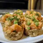 Creamy salmon, green peas, and dill appetizer bites on a white plate, garnished with fresh herbs, highlighting Waggy Chef's homemade healthy pet food recipes.