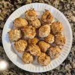 Creamy coconut chicken meatballs on a white plate, crispy and flavorful; perfect for pet dogs or cats.