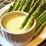 Fresh asparagus with creamy hollandaise sauce for healthy gourmet recipes at Waggy Chef. Perfect for elegant appetizers or side dishes.