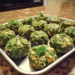 Savory veggie energy bites with greens and nuts on a silver tray healthy snack recipe vegan gluten-free.