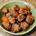 Tender beef stew meatballs with carrots served in a green bowl, showcasing savory homemade pet food from Waggy Chef. Perfect for nutritious dog meals or pet treats.