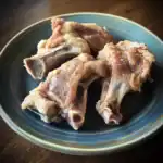 Succulent raw beef short ribs on a ceramic plate, ready for cooking or grilling. Perfect for making flavorful stews, barbecues, or braised meat dishes. Fresh, high-quality beef ribs from Waggy Chef.