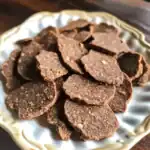 Rich, homemade beef jerky on decorative plate, perfect for dog treats and pet snacks. High-quality, flavorful, and nutritious dog-friendly jerky for healthy treats.