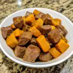 Savory beef stew with tender meat and chunky sweet potatoes in a rich, flavorful broth, perfect for hearty comfort food and nutritious family meals.